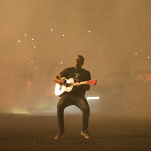 Sam Sam playing the guitar during his stunt.