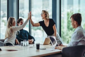 employees high five their senior