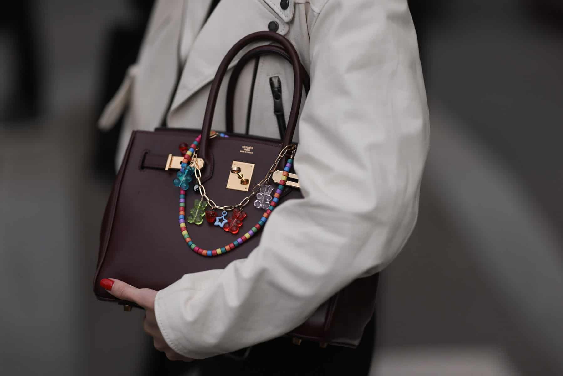 A winered Hermès birkin bag with colourful bag chains outside Miu Miu Show during the Womenswear Fall/Winter 2024/2025 as part of Paris Fashion Week on March 05, 2024 in Paris, France. Picture via Jeremy Moeller/Getty Images)