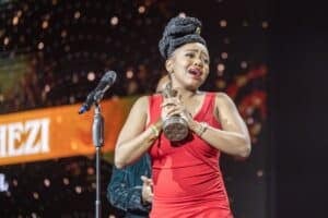An emotional Sibongiseni Shezi gestures after receiving the "Best Actress Film " award