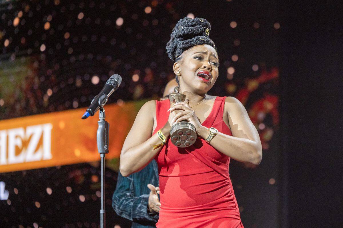 An emotional Sibongiseni Shezi gestures after receiving the "Best Actress Film " award