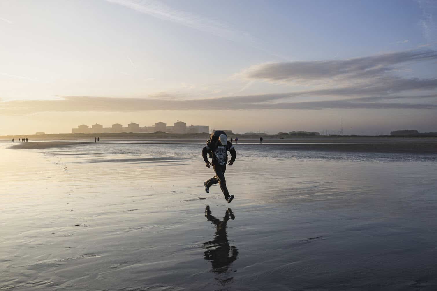 A migrant runs to board a smuggler's inflatable dinghy