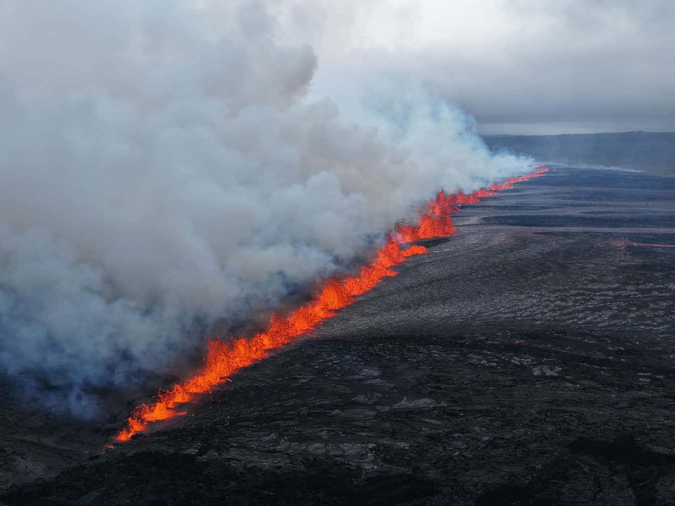 lava and smoke erupting from a volcano