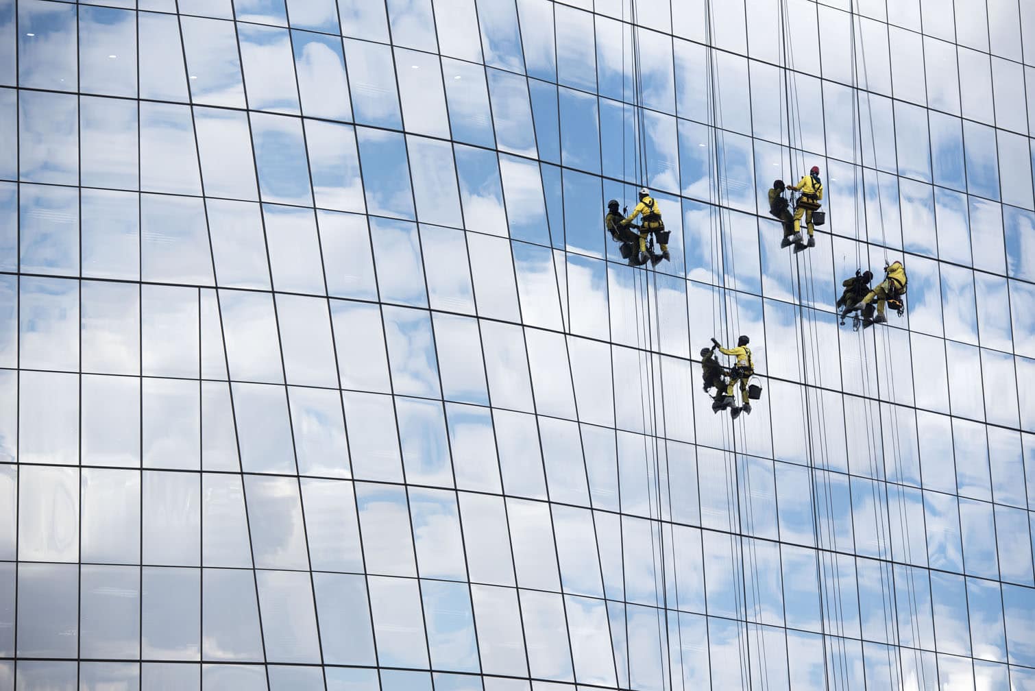 Workers clean the windows of the Anglo American De Beers Group building