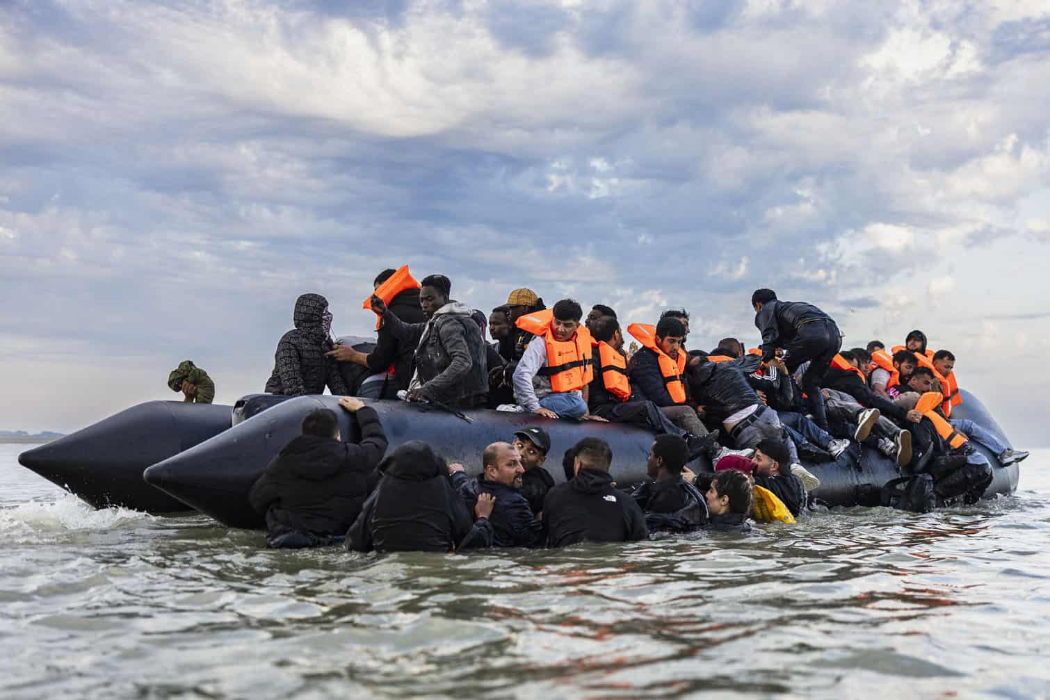 Migrants try to board a smuggler's boat