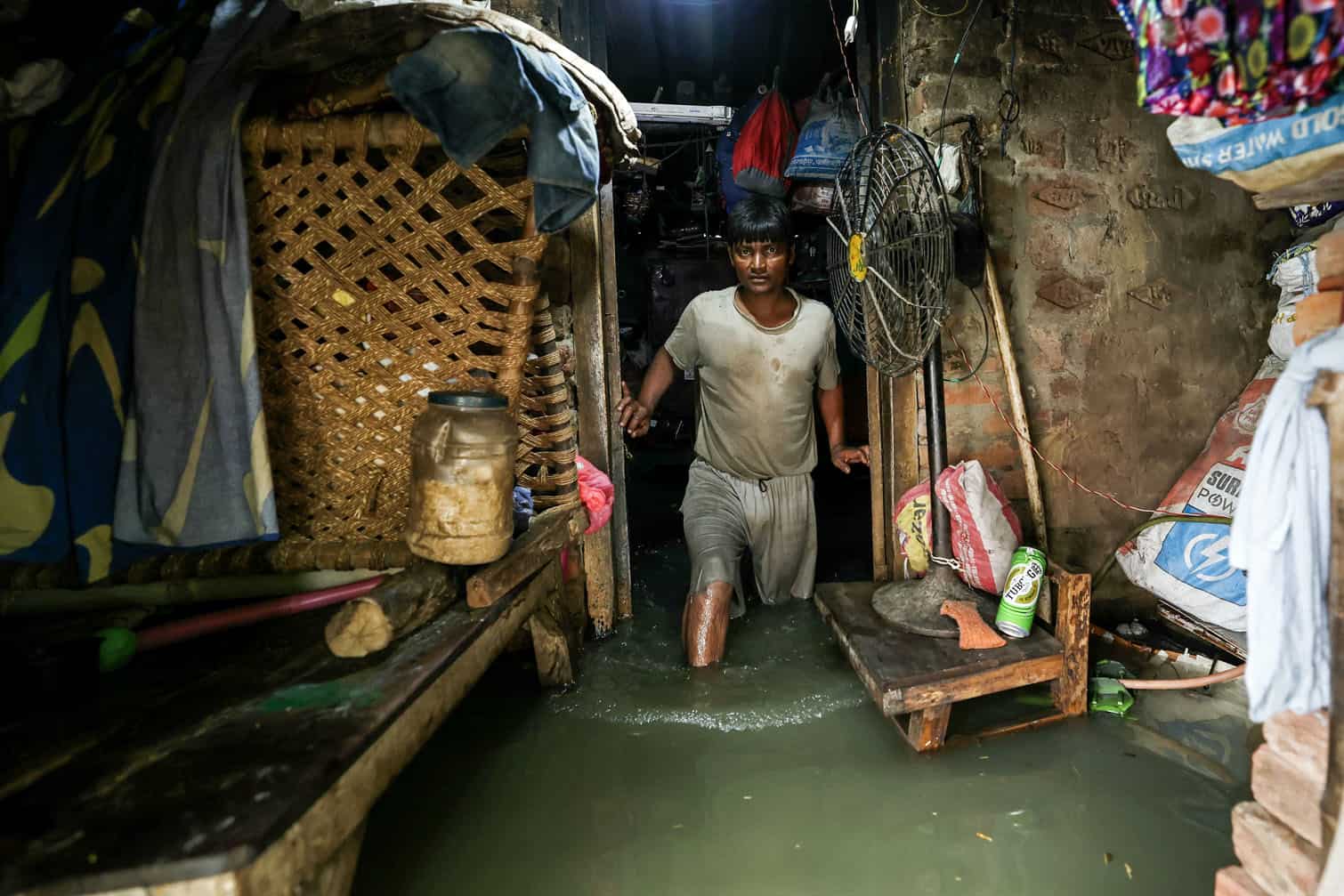 A man wades through floodwaters