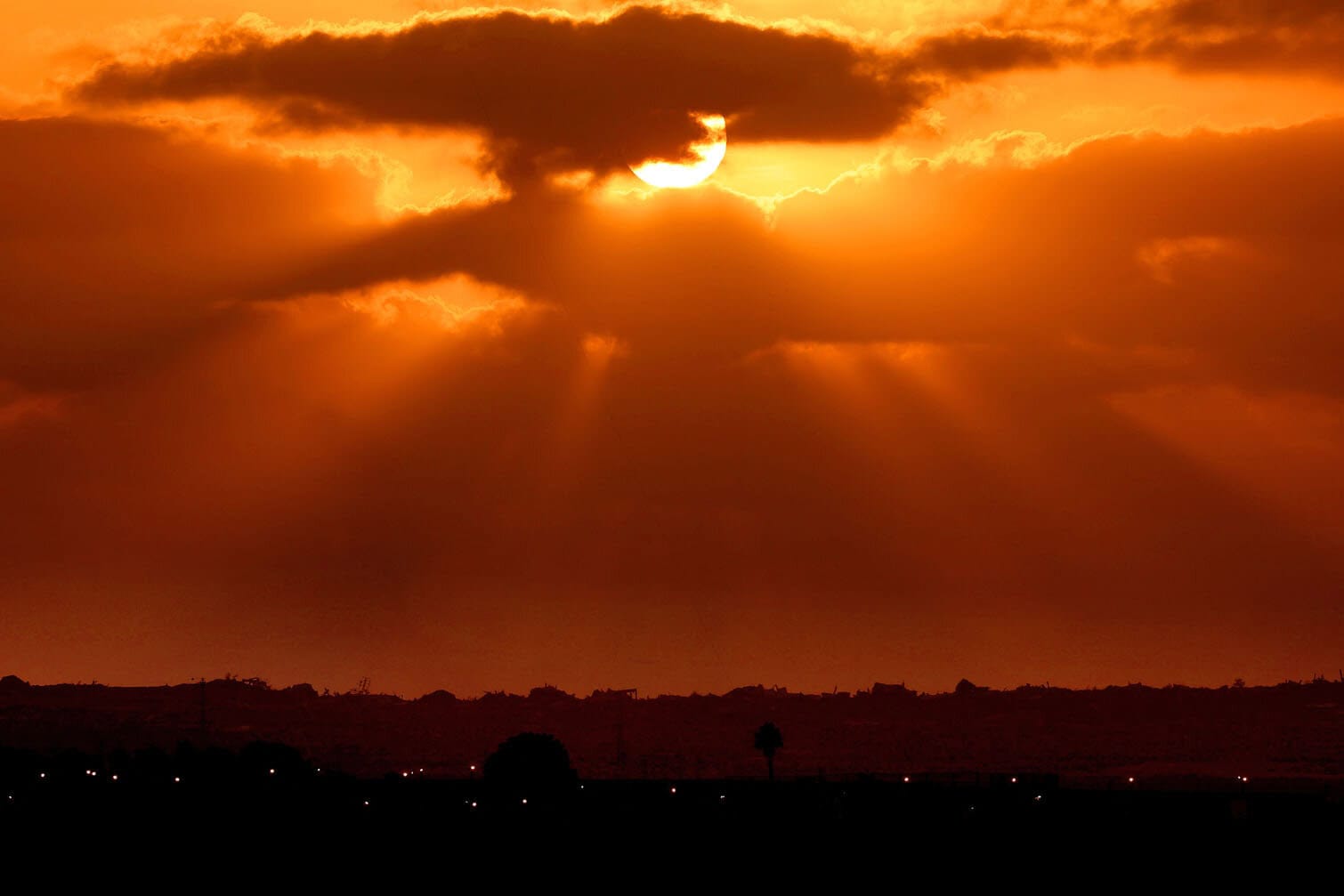 Sunset over the horizon with dramatic clouds and rays of sunlight in South Africa.