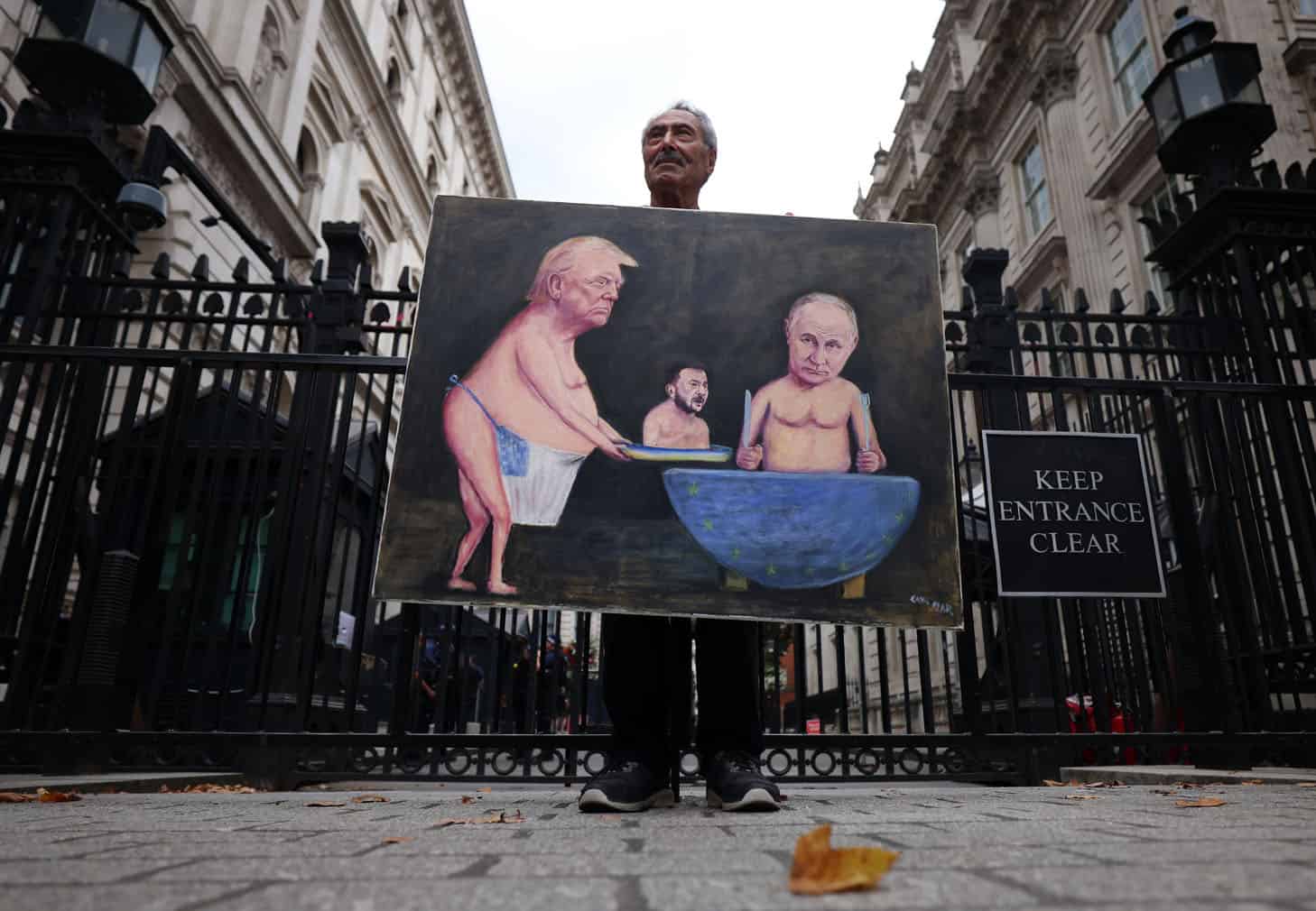 Political satire artist Kaya Mar shows his artwork of Trump, Zelensky and Putin in London