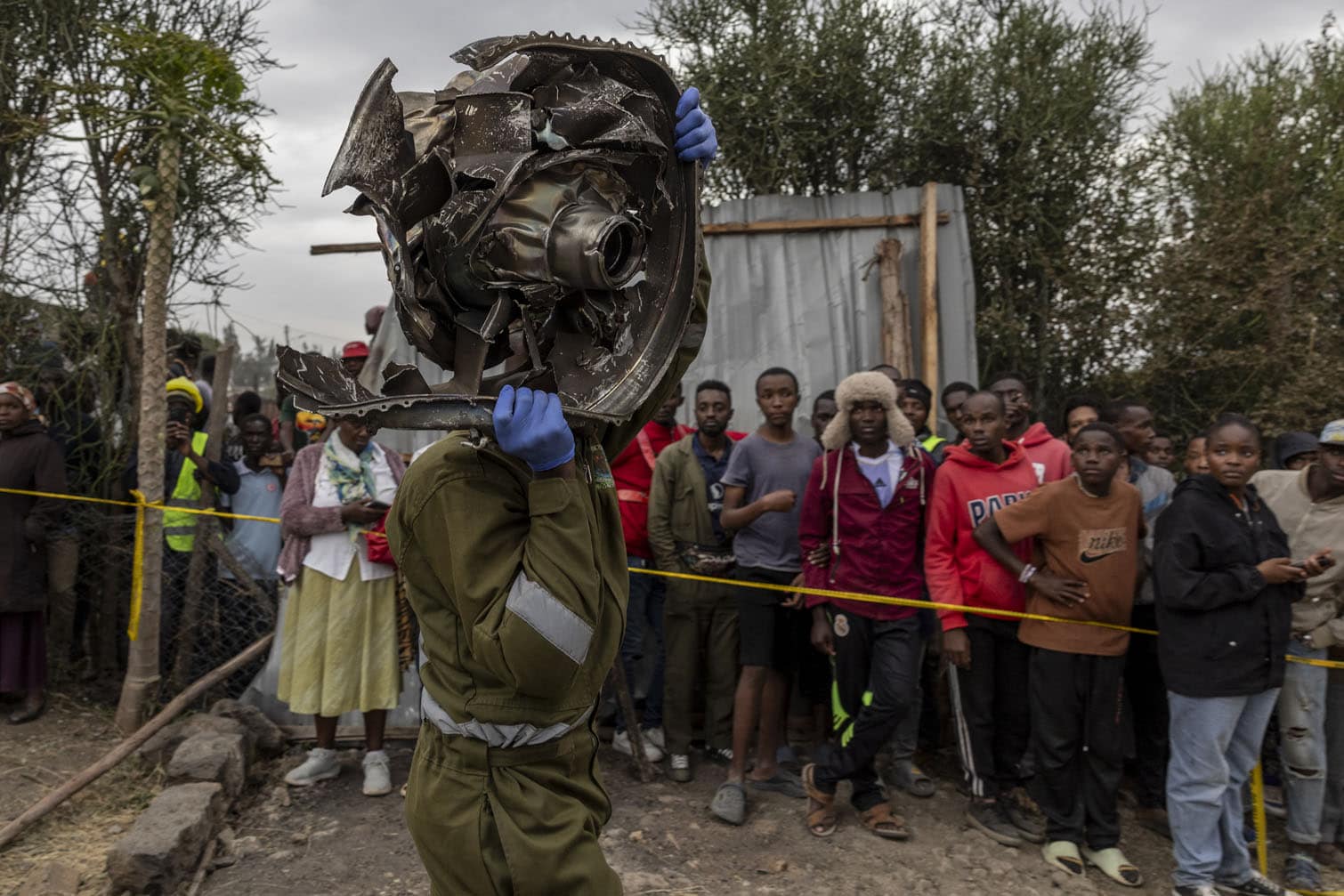 A rescuers carries part of a plane