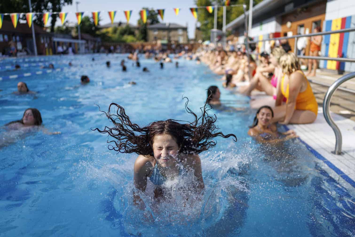 Outdoor swimming at London Fields Lido during a heatwave in the UK