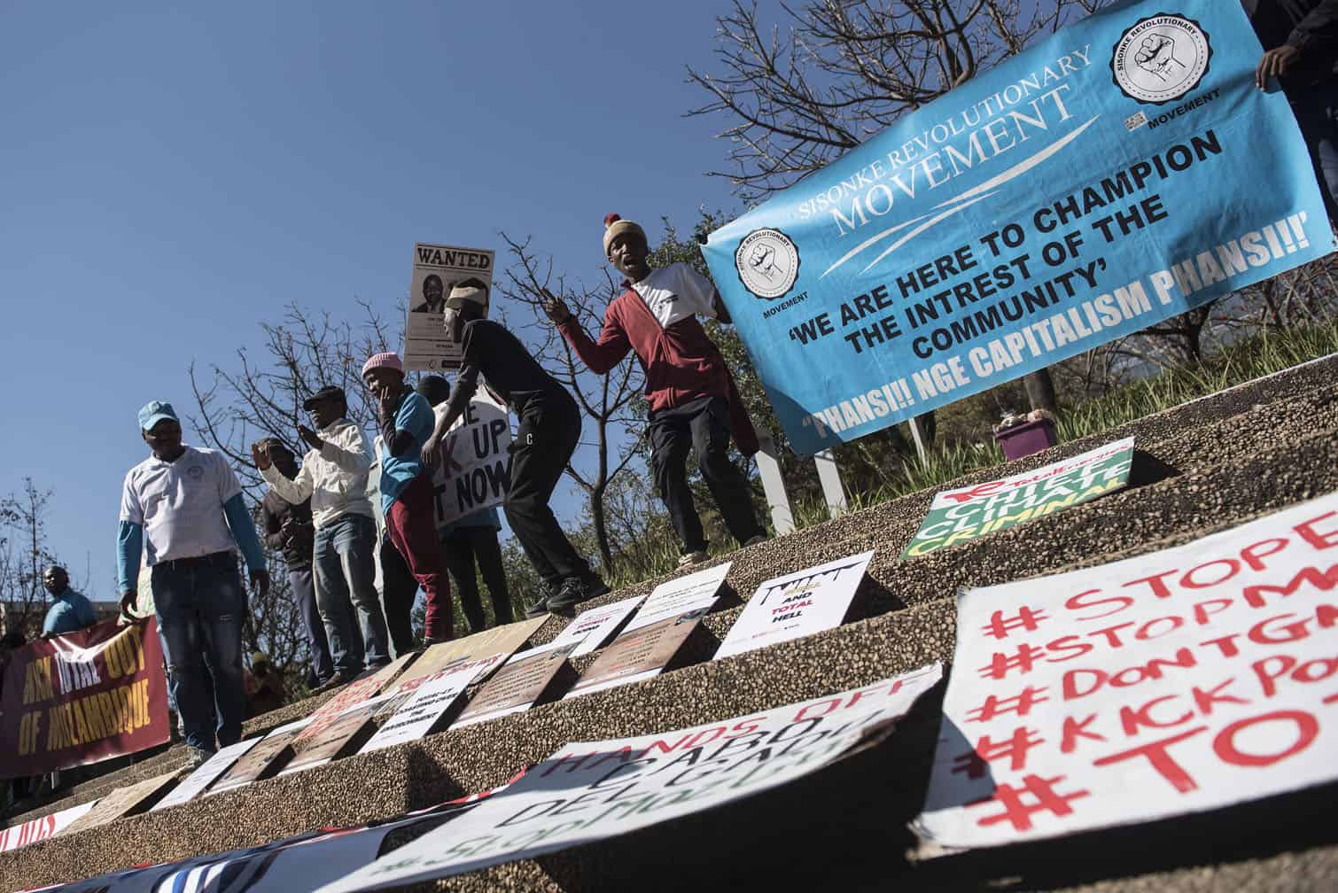 Environmental protesters demonstrate against Total