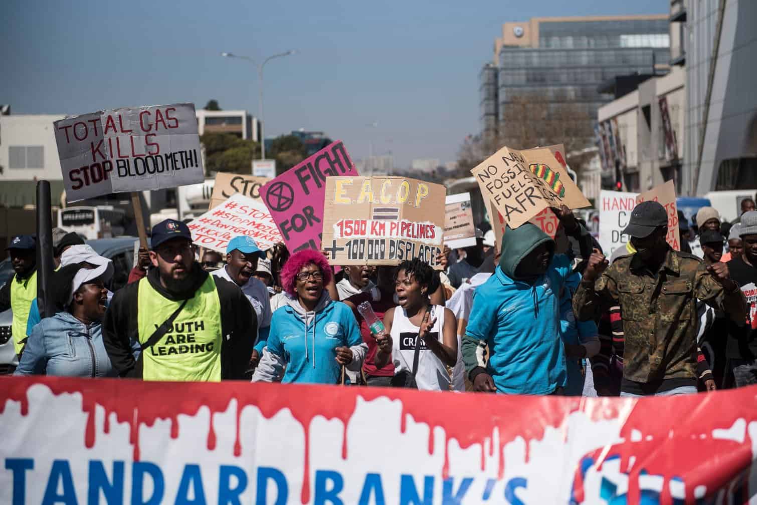 Environmental protesters demonstrate against Total
