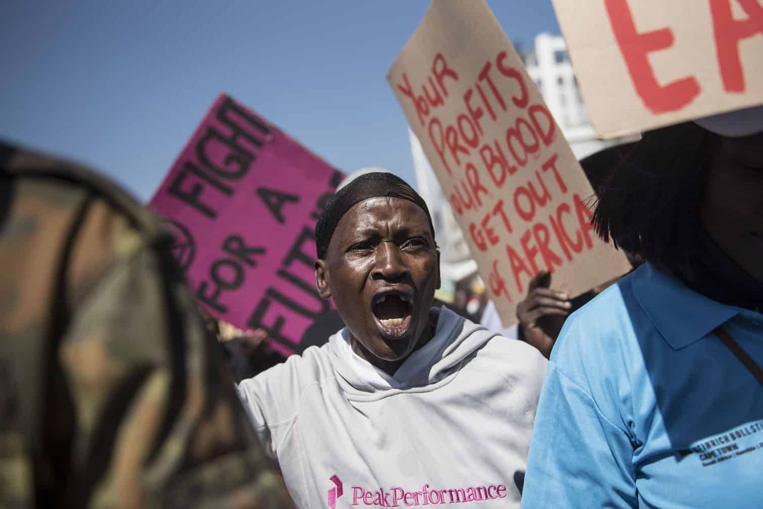 Environmental protesters demonstrate against Total