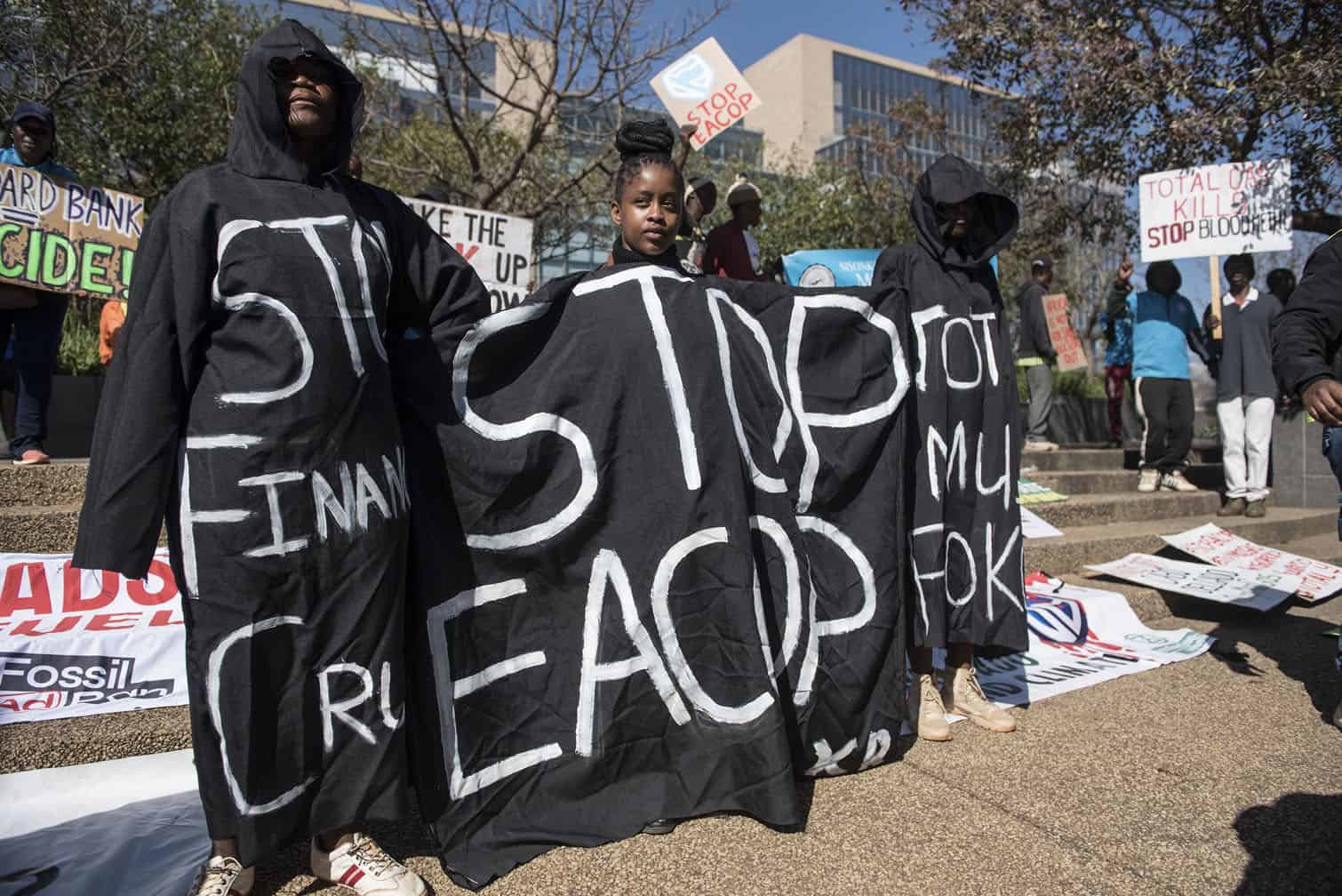 Environmental protesters demonstrate against Total