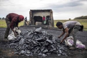 Artisanal miners Mpuyisa Sabelo, 33 and Lucky Jokiwe, 38, collect coal before loading a pickup truck in Ermelo, Mpumalanga