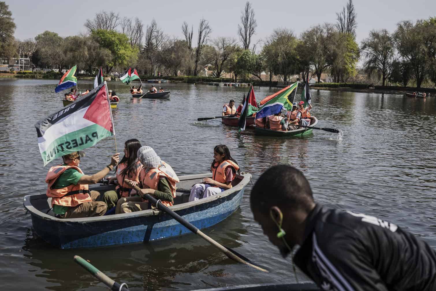 Activists wave South African and Palestinian flags