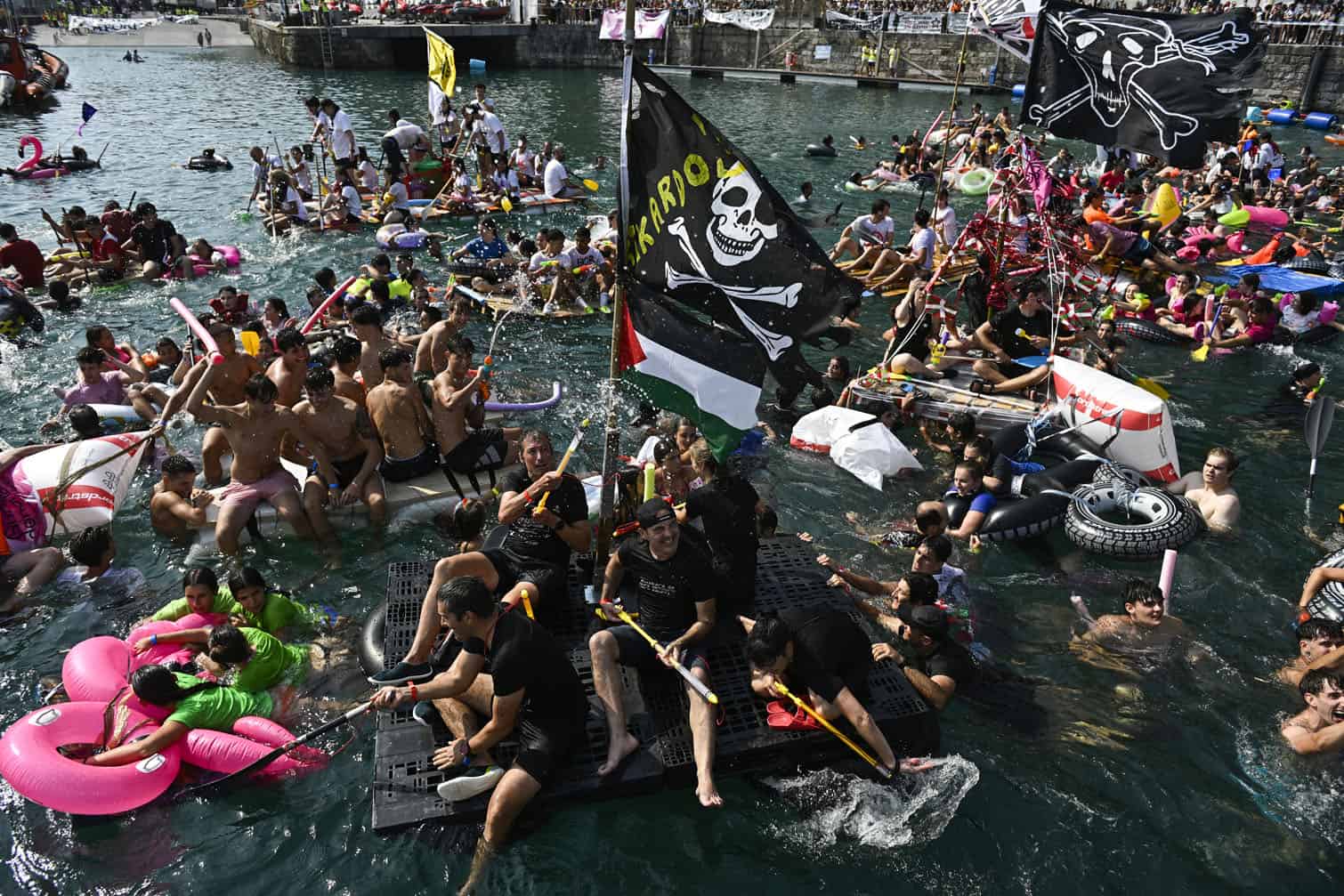Revellers leave the port on makeshift rafts