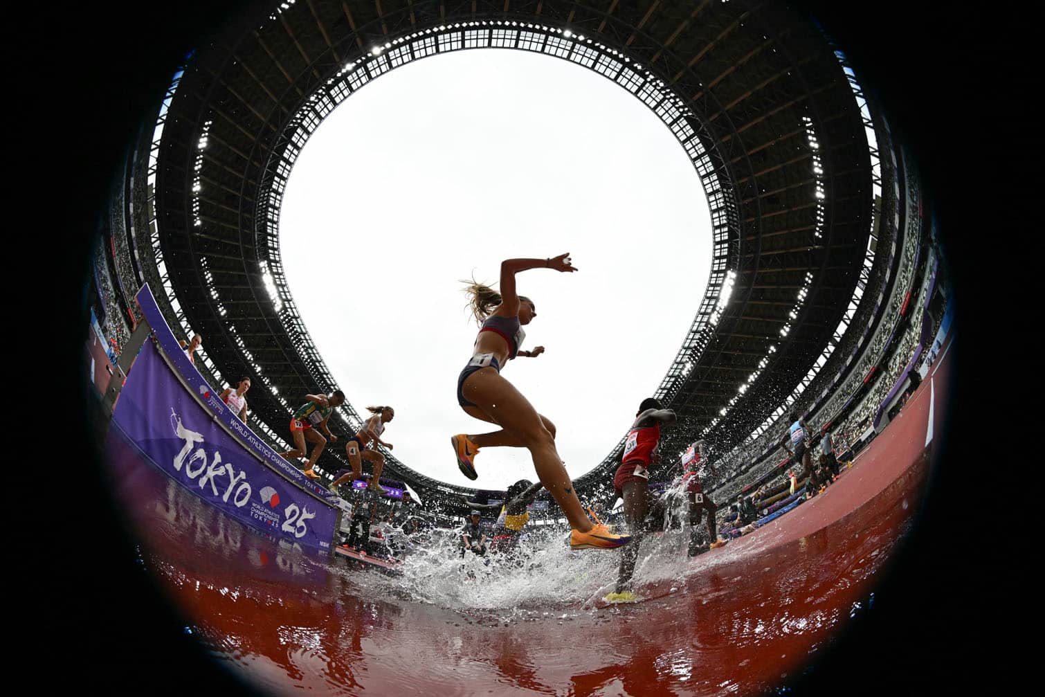 Athletes compete in the women's 3000m steeplechase