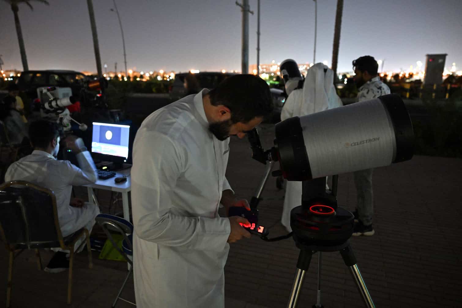 Kuwaitis follow the phases of the total lunar eclipse in Kuwait City