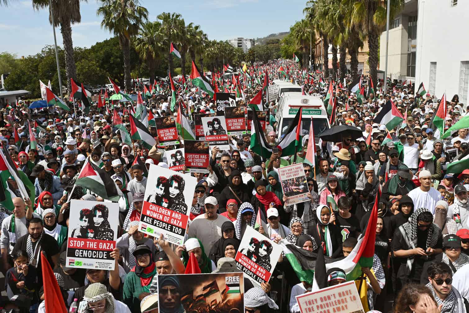Protesters hold placards
