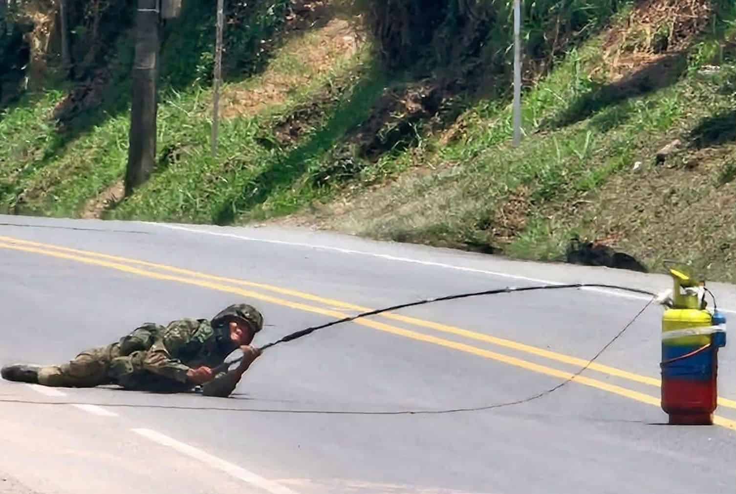 a soldier working on deactivate a gas cylinder