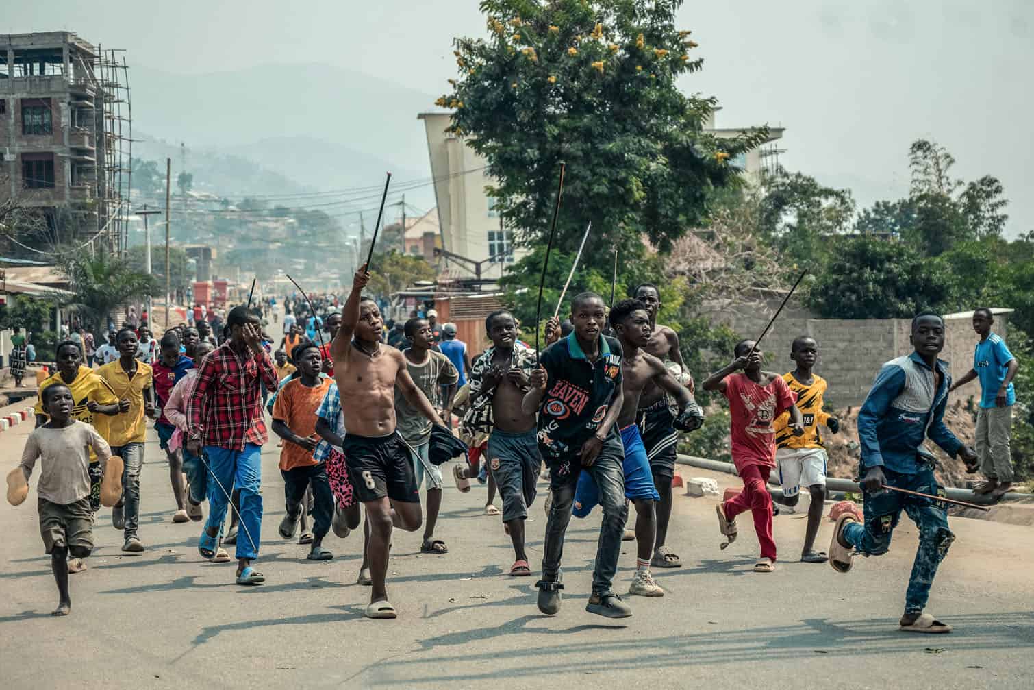 A group of protesters brandish sticks