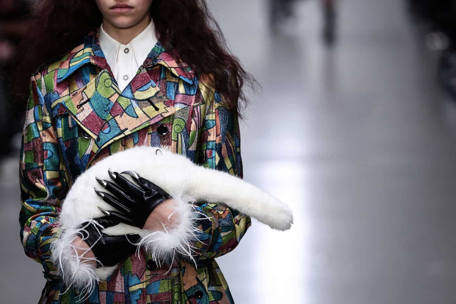 A model presents gloves and a bag by Anrealage f