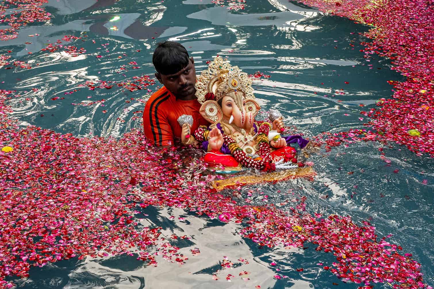 A volunteer immerses an idol