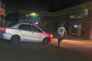Officer stopping vehicle in road block