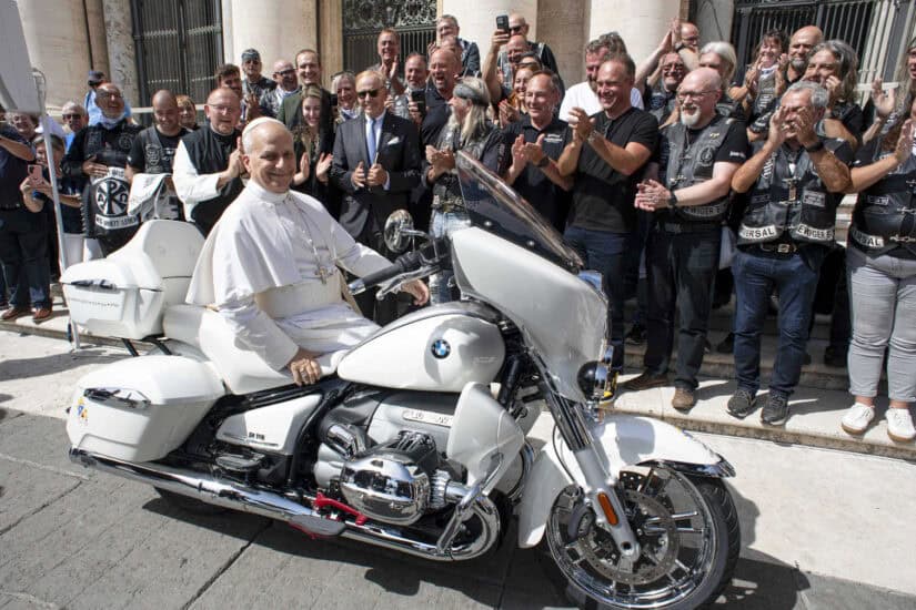 Pope Leo XIV posing on a a white BMW R18 motorbike
