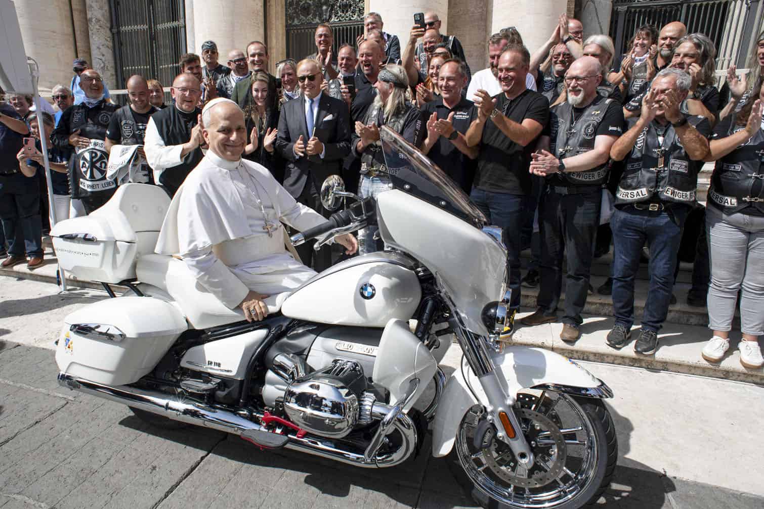 Pope Leo XIV posing on a a white BMW R18 motorbike