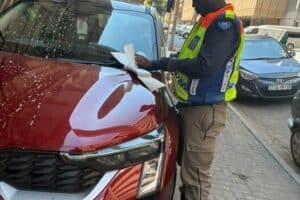 JMPD officers issue fines to motorists illegally parking on pavements, protecting pedestrian safety in Johannesburg.