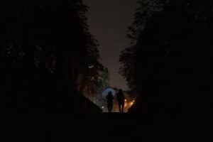 People walk down the street with umbrellas during a power outage in Kyiv on October 10, 2025, following a Russian missiles and drones attacks.