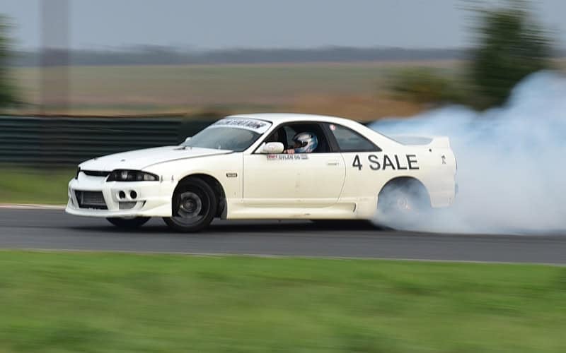 Nissan Skyline drifting on a track
