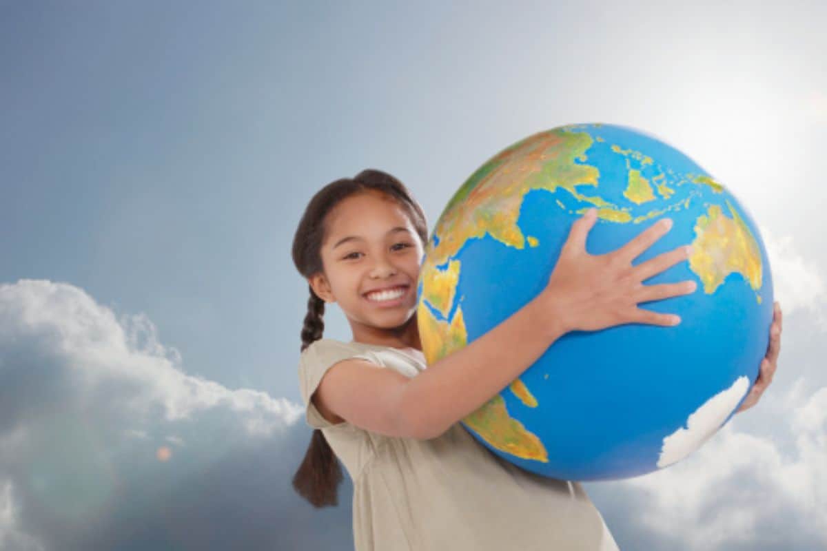 A young girl holding the globe