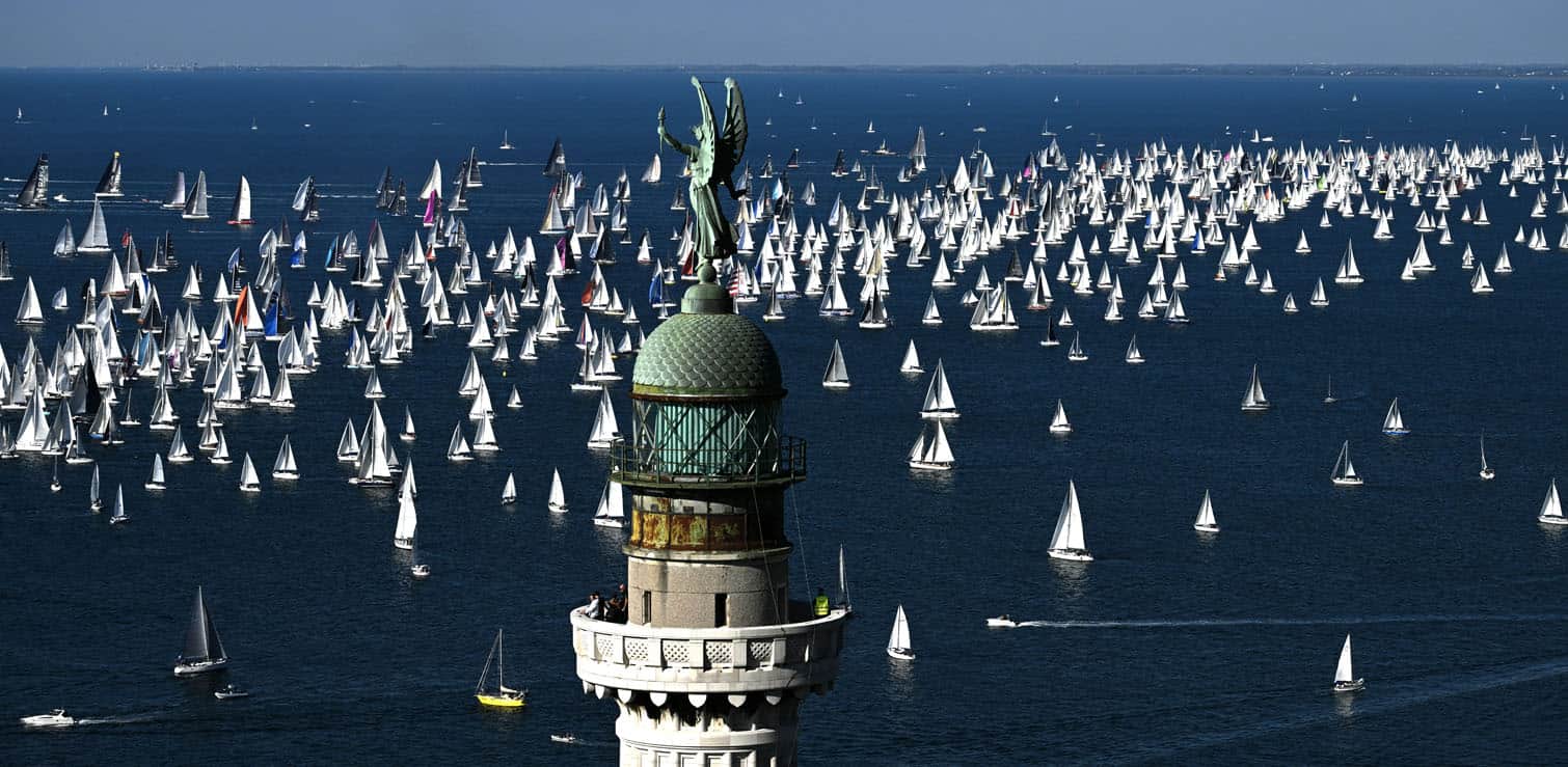 boats sailing past the lighthouse Vittoria Light