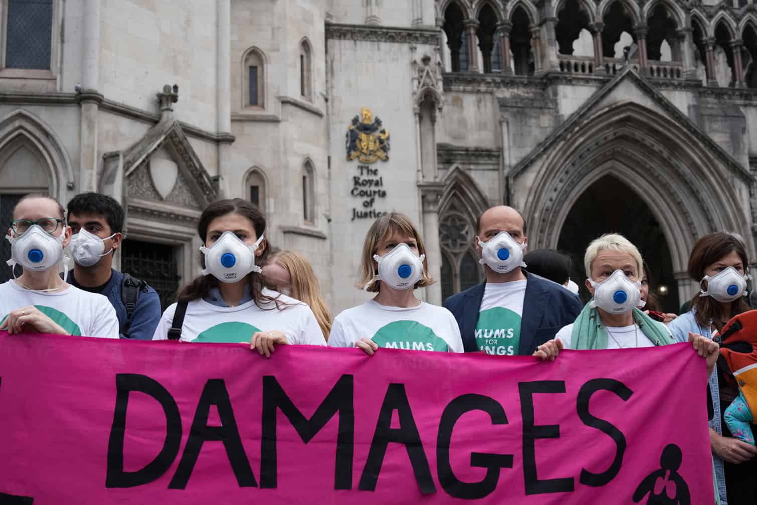 Protesters gather outside the Royal Courts of Justice