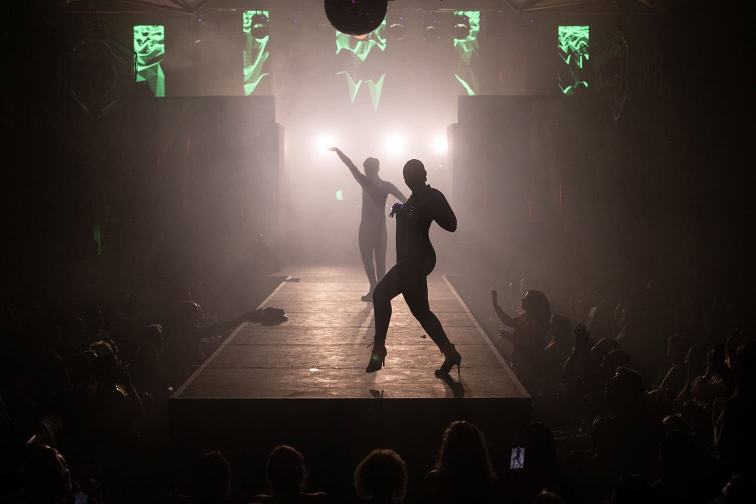 People dance on the runway at the 'Blockbuster Ball'