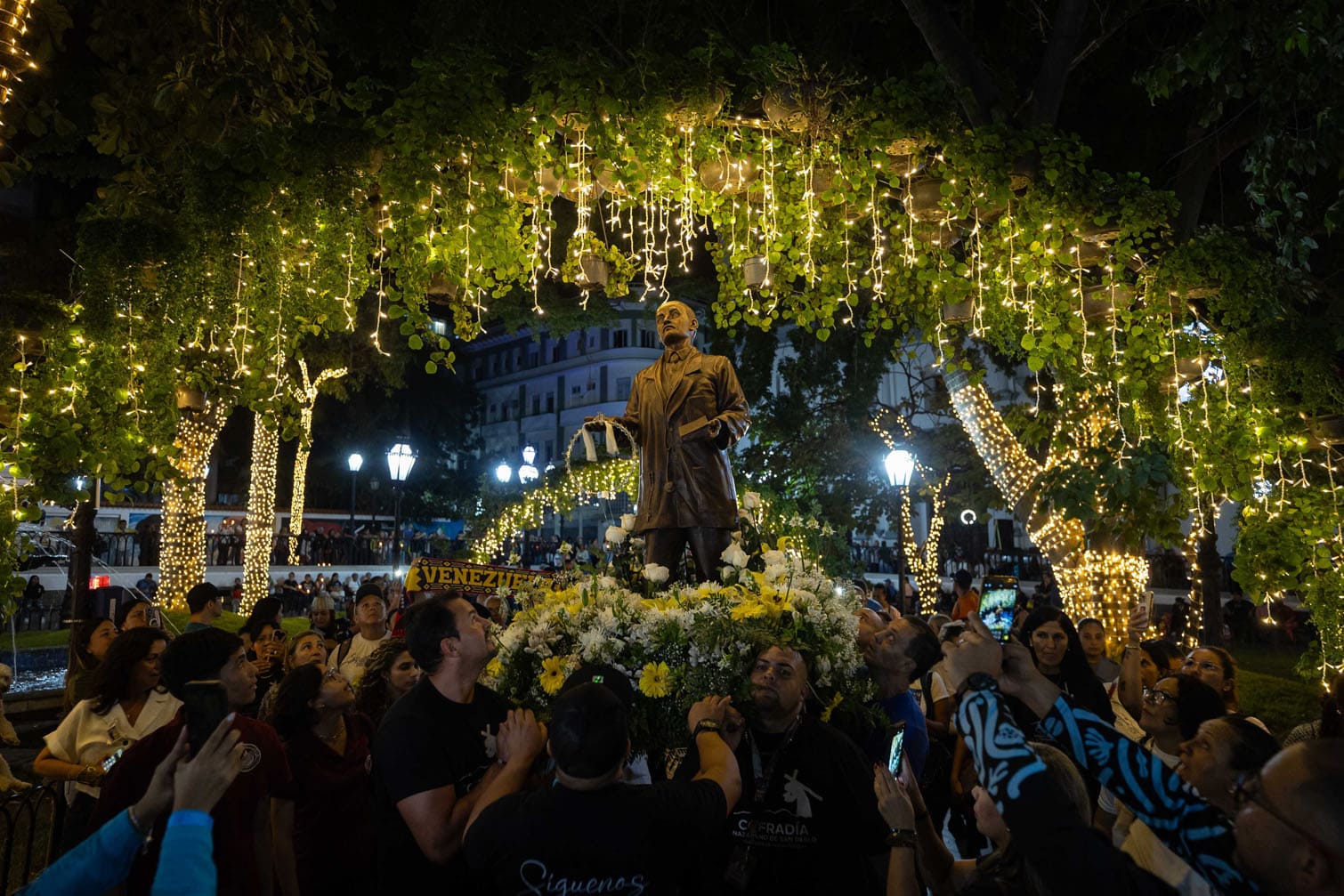 Devotees honor Jose Gregorio Hernandez and light candles for peace in Venezuela