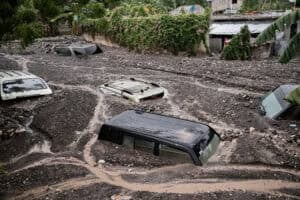 Cars are submerged in mud following Hurricane Melissa