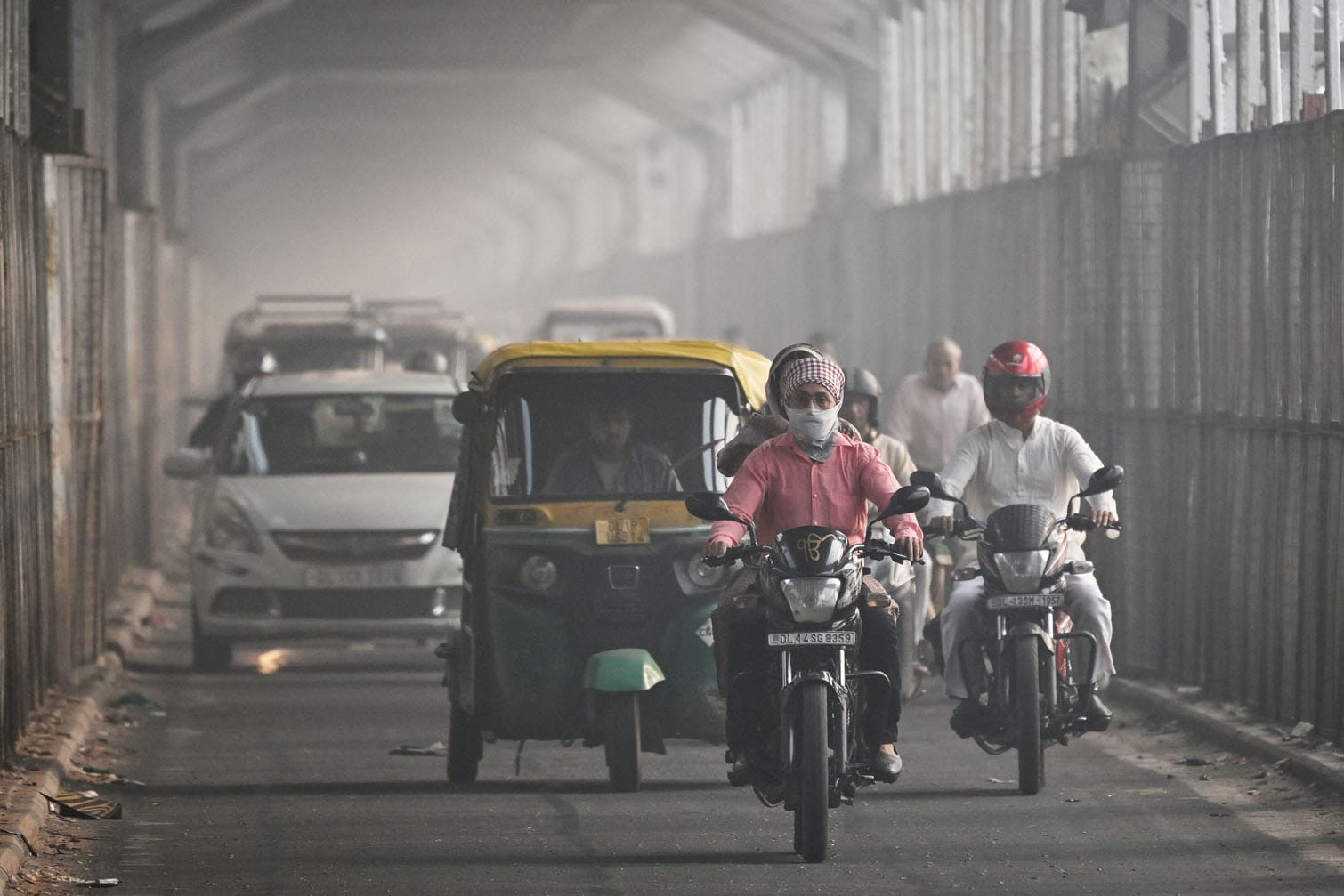 A commuter with his face covered in cloth