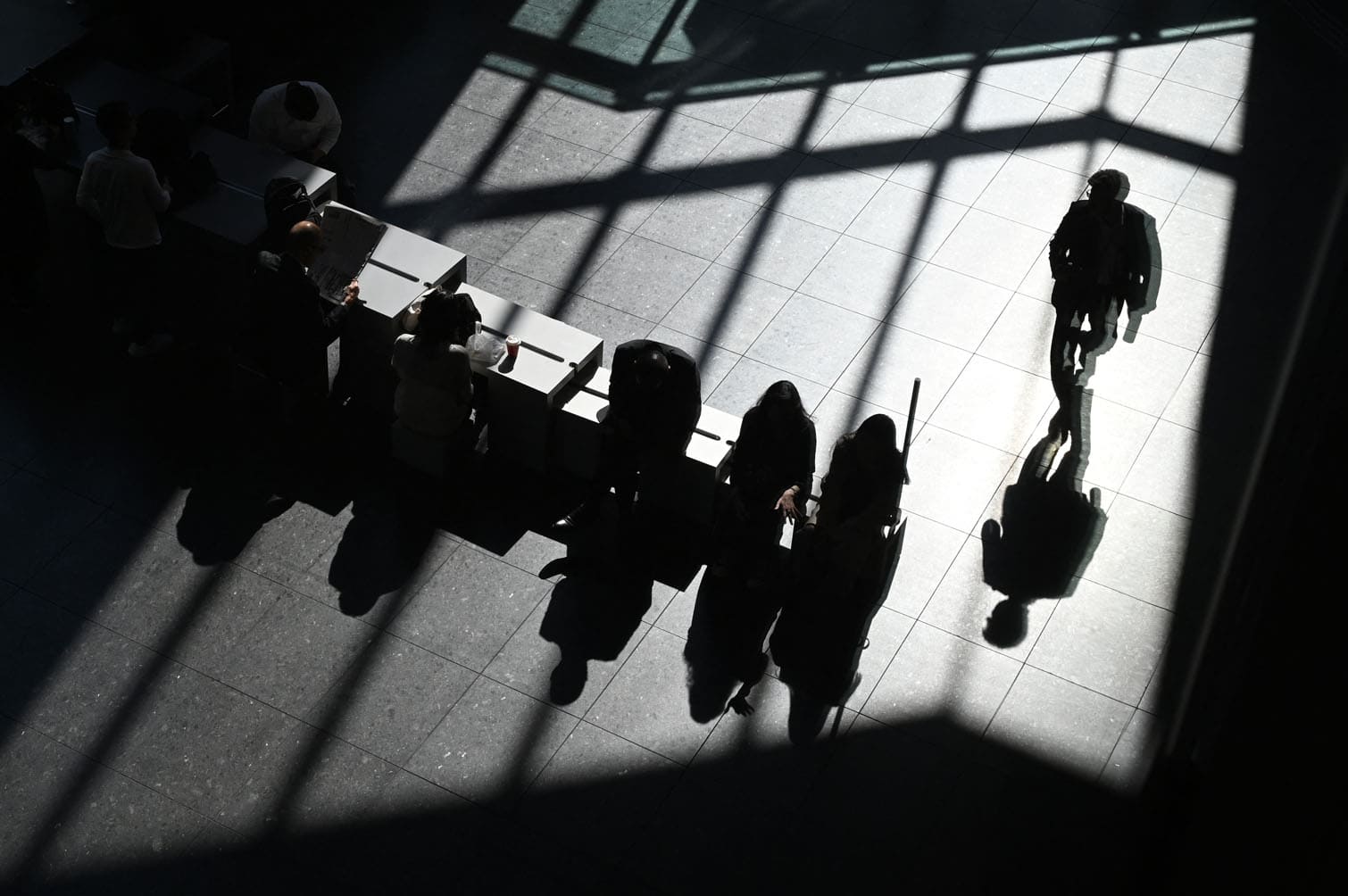 People rest in the lobby of an office building in Tokyo