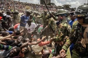 Kenya Police officers control the crowd