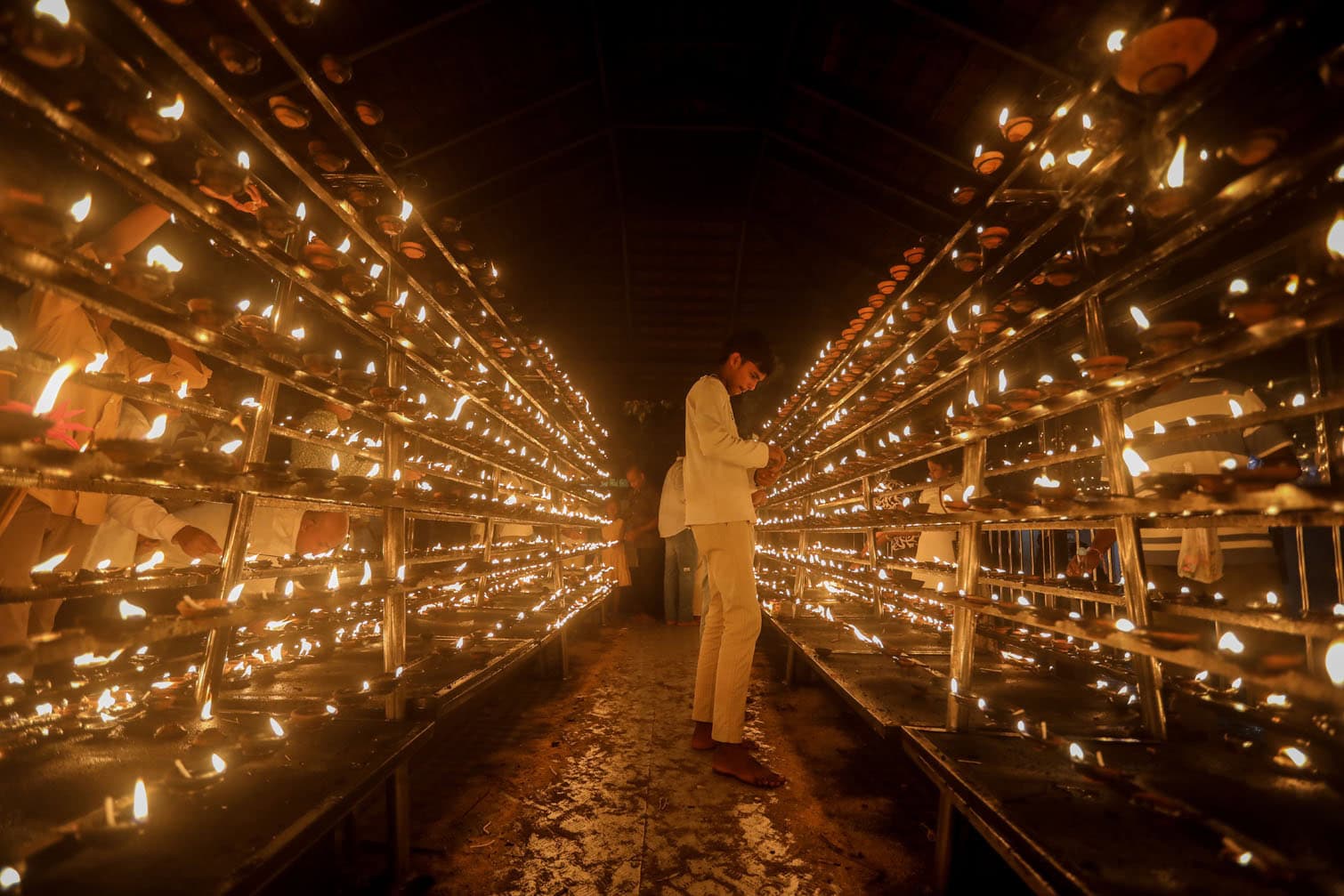 Buddhists visit temple for Full Moon Poya Day religious evening observance in Colombo