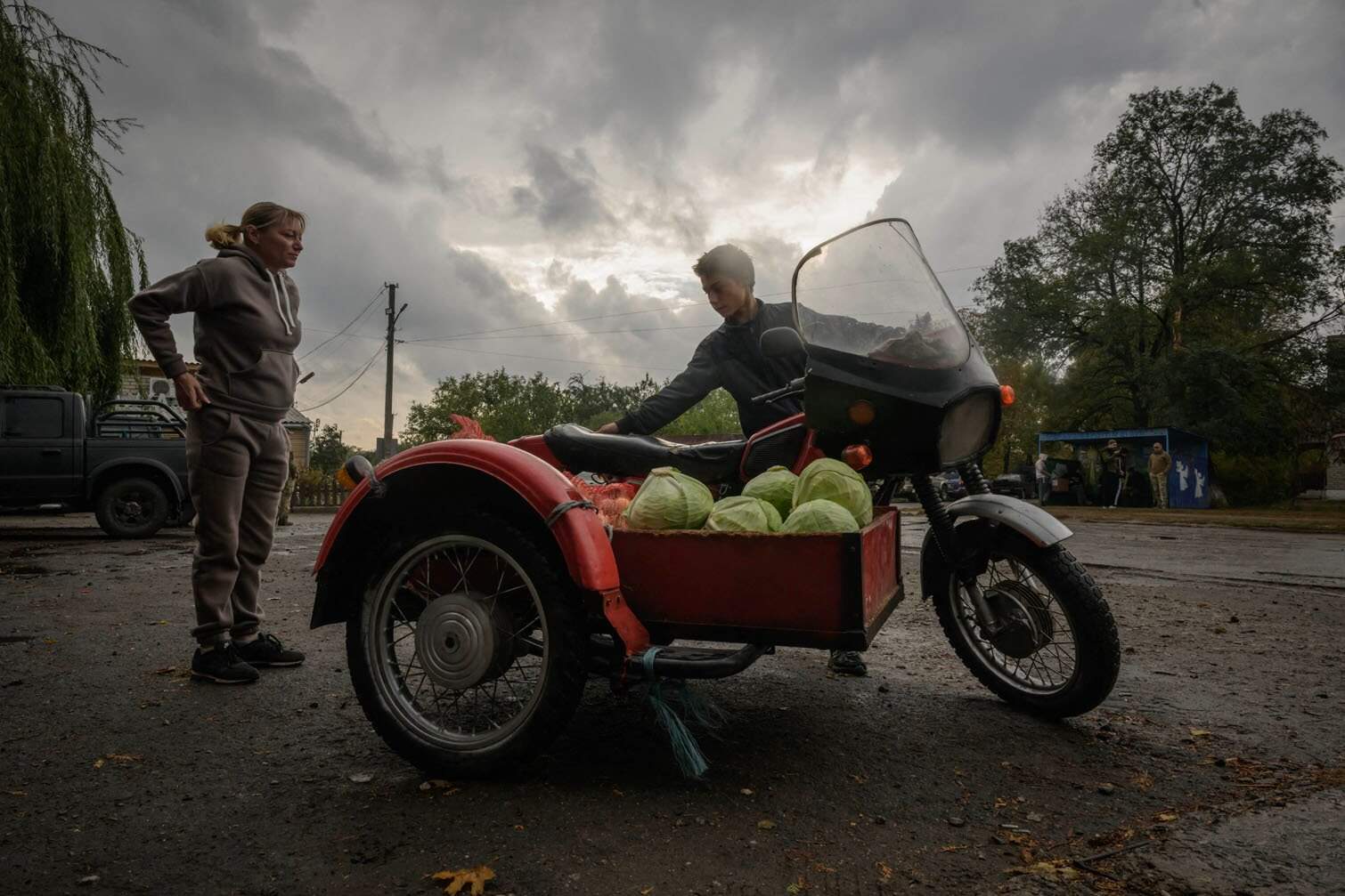 a motorcycle loaded with cabbages