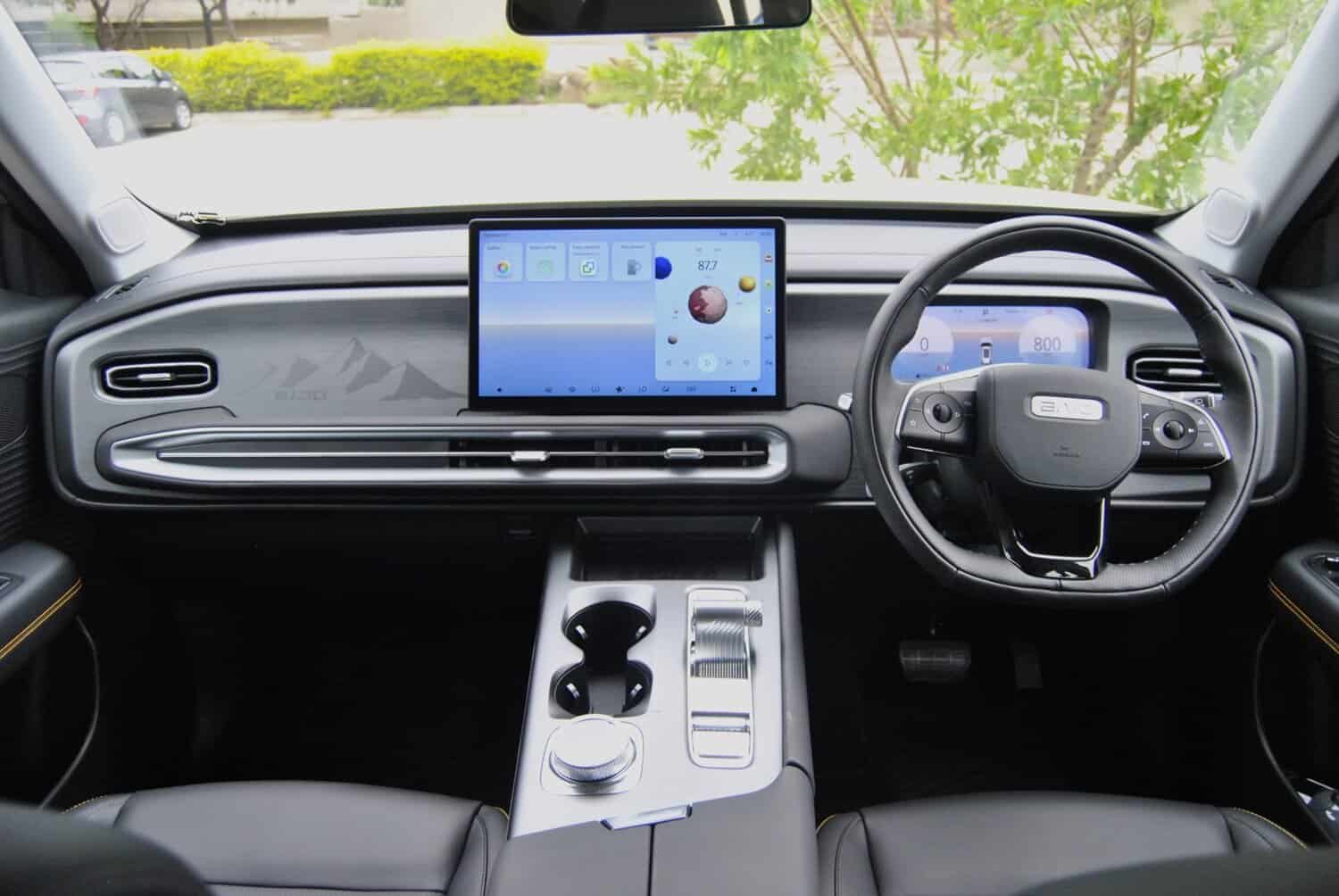 Futuristic car interior with digital dashboard and touchscreen display, showcasing advanced vehicle technology.
