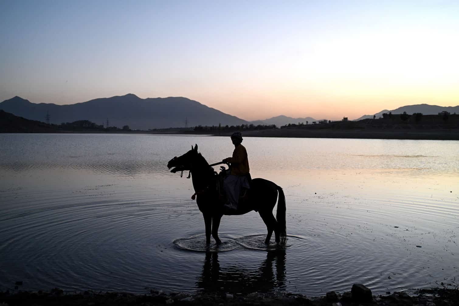 An Afghan boy rides a horse
