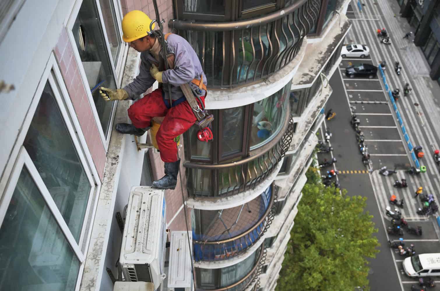 A worker cleans a glass window