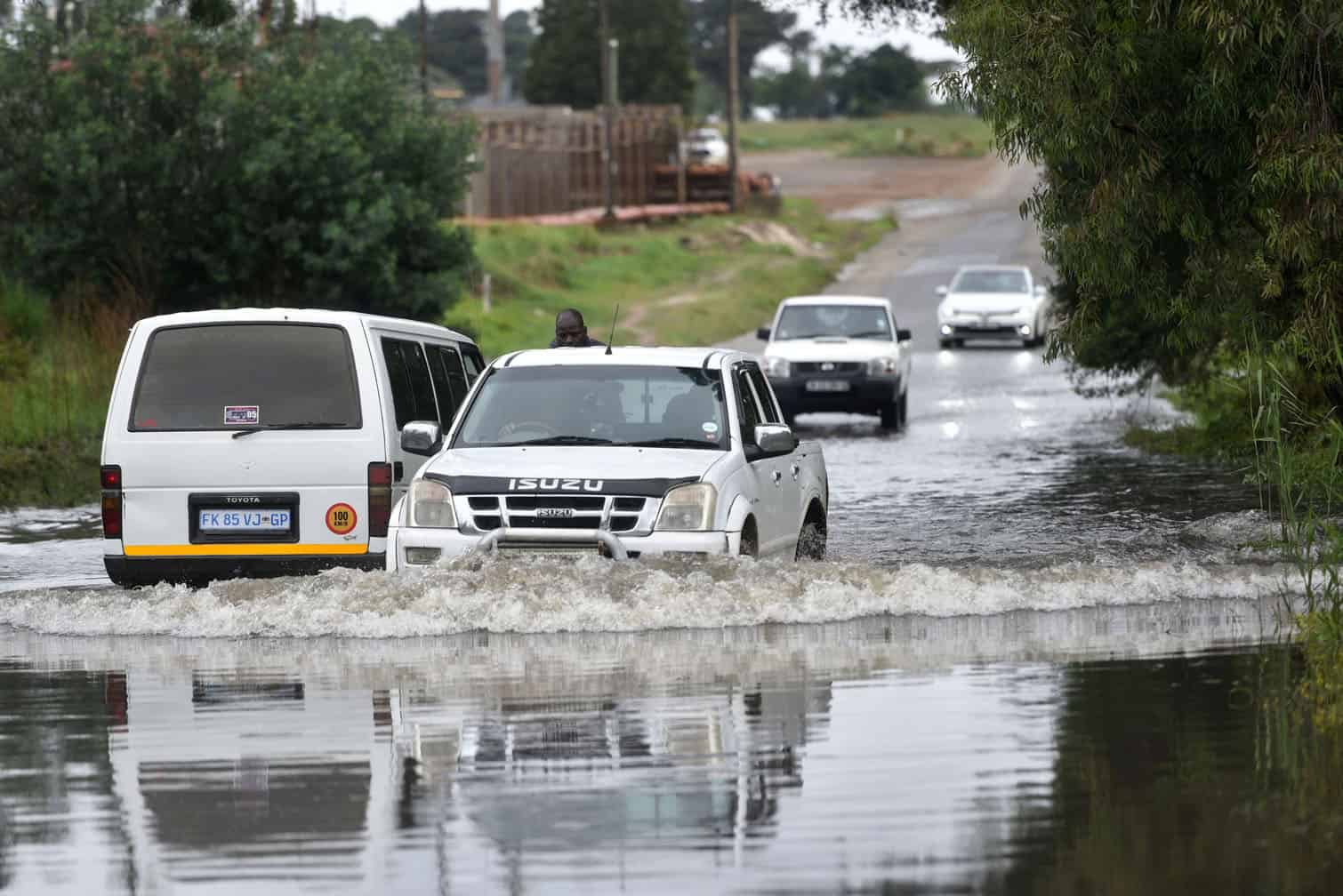 A vehicle drives past a flood