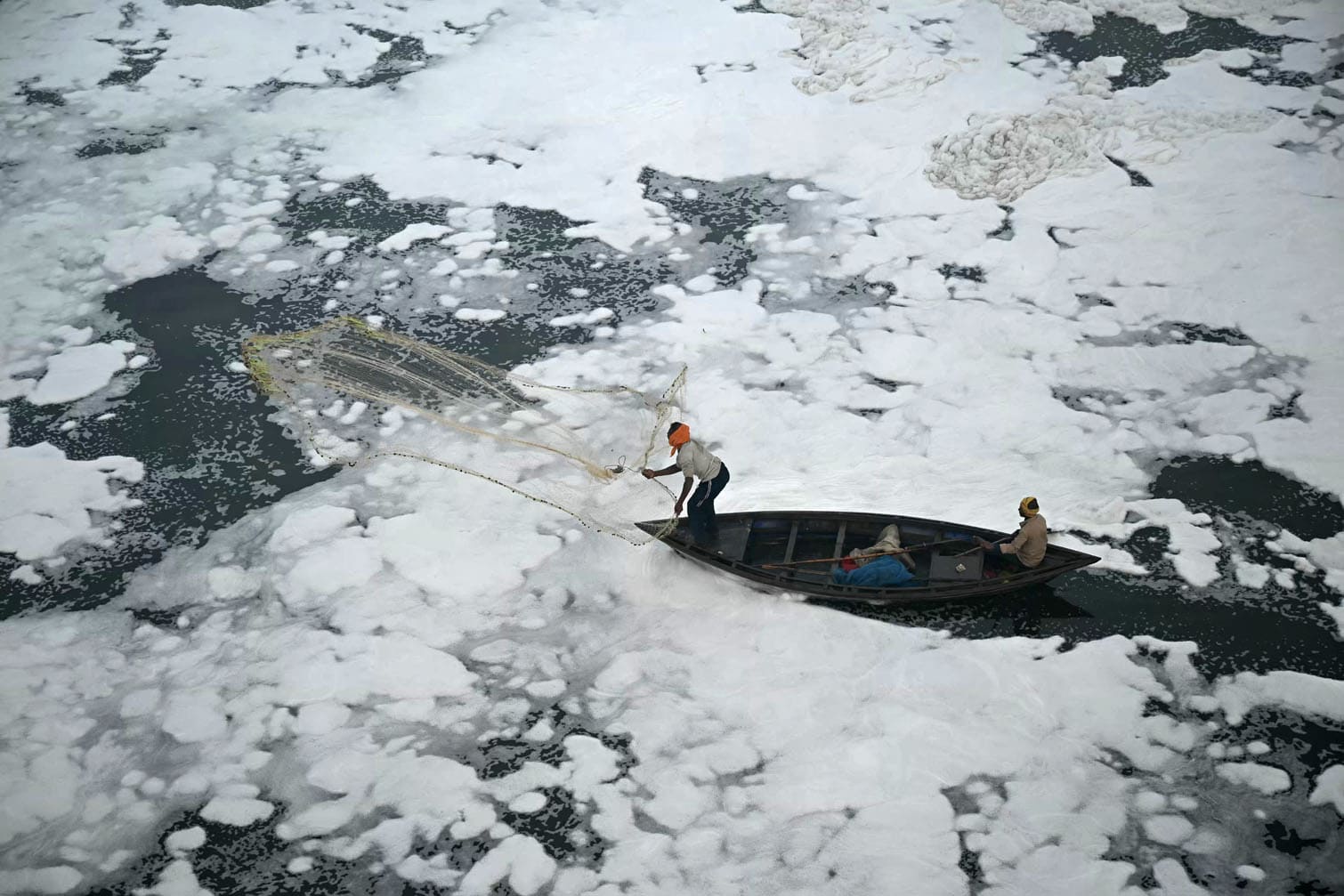 A fisherman casts his net